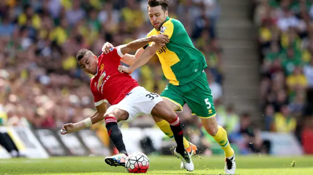 Jesse Lingard and Ivo Pinto battle for possession