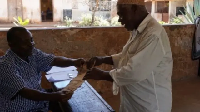 A man in Zanzibar receiving his pension