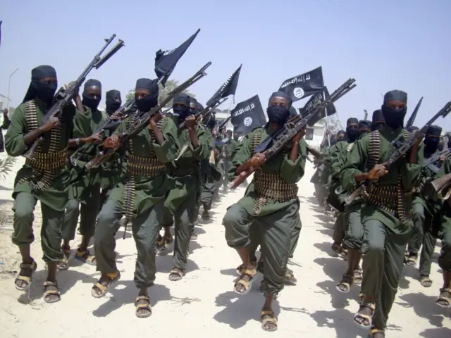 In this Thursday, Feb. 17, 2011 file photo, al-Shabab fighters march with their weapons during military exercises on the outskirts of Mogadishu, Somalia