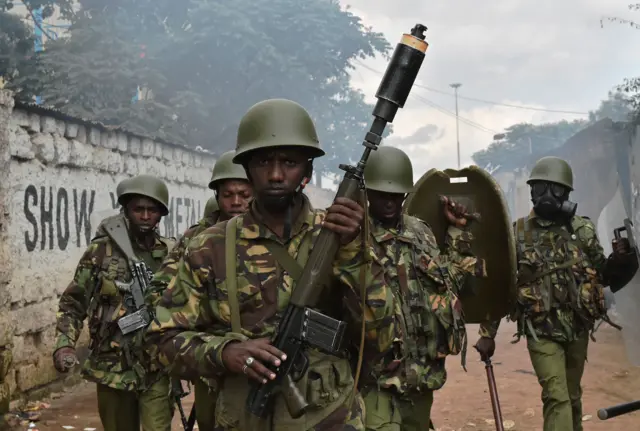 Riot policemen patrol in Kibera slum, Nairobi on May 23, 2016 during a demonstration of opposition supporters protesting for a change of leadership at the electoral commission ahead of a vote due next year. Local media reported at least one killed in Kisumu in the west of the country,