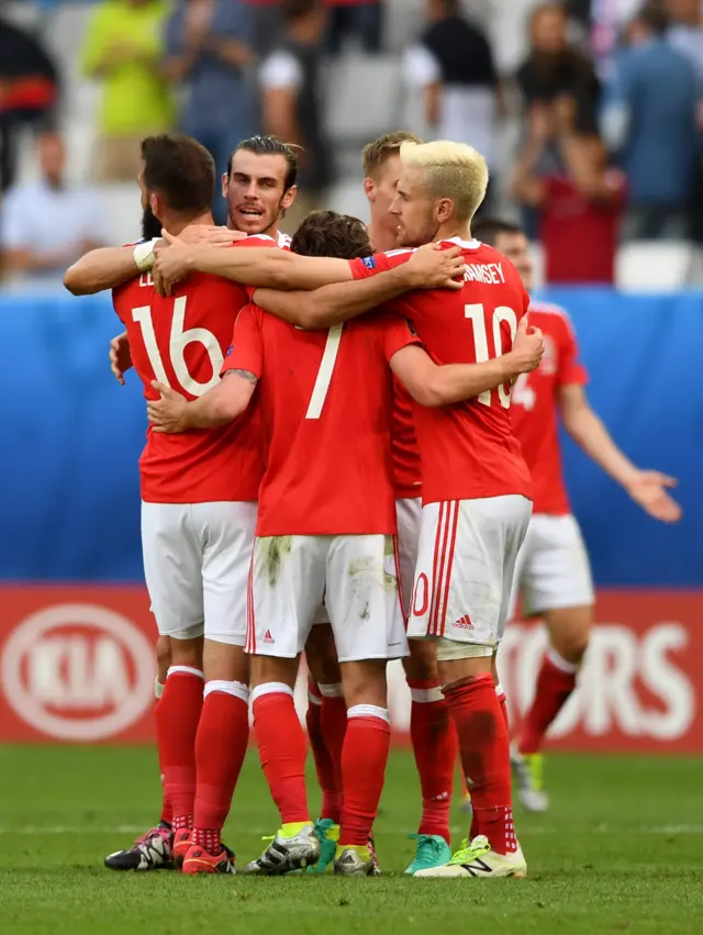 Wales players celebrate their 2-1 win over Slovakia at full-time