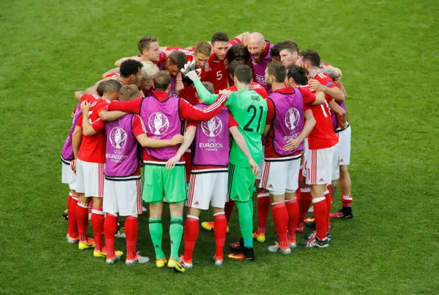 Wales' players huddle on the pitch after their 2-1 against Slovakia