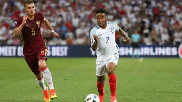 Raheem Sterling runs with possession