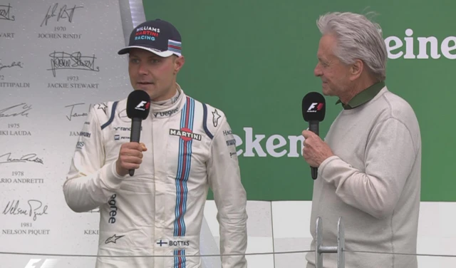 Valtteri Bottas with Michael Douglas on the podium