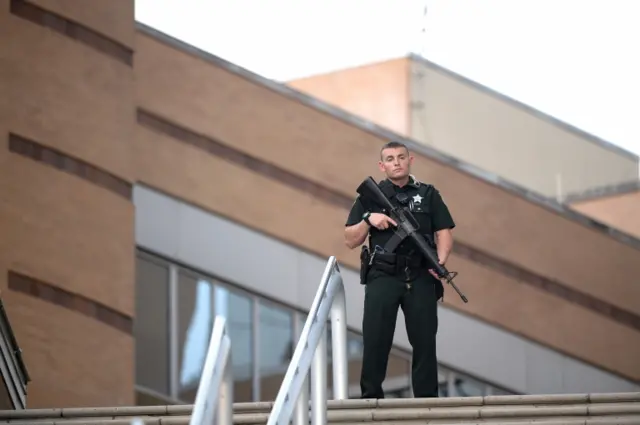 A police officer stands guard outside the Orlando Regional Medical Center hospital