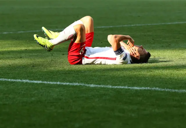 Robert Lewandowski goes down for Poland