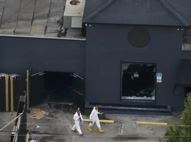 Police forensics investigators work at the crime scene of a mass shooting at the Pulse gay night club in Orlando, Florida, U.S. June 12, 2016.