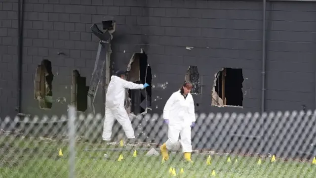 FBI agents investigate near the damaged rear wall of the Pulse