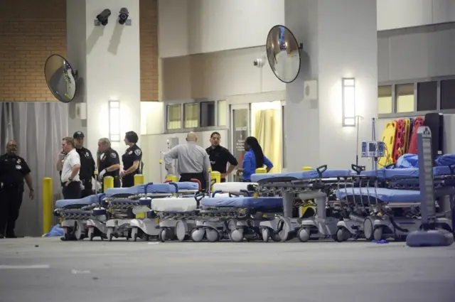 Emergency personnel wait with stretchers at the emergency entrance to Orlando Regional Medical Center hospital