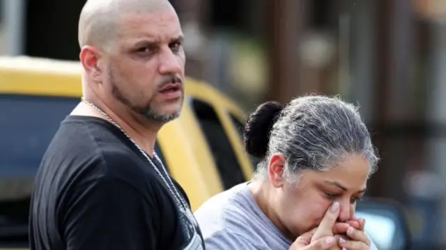 Ray Rivera, a DJ at the Pulse club, is consoled by a friend