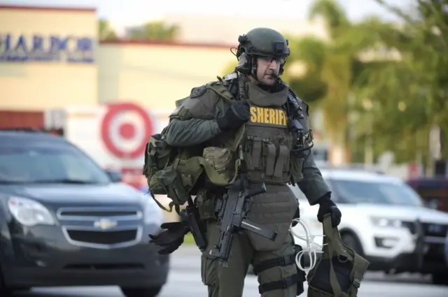 An Orange County Sheriff's Department SWAT member arrives at the scene of a fatal gun attack at Pulse Orlando nightclub