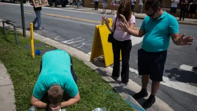 pray for victims a few blocks from a crime scene at the nightclub where a mass shooting took place the night before in Orlando, Fla