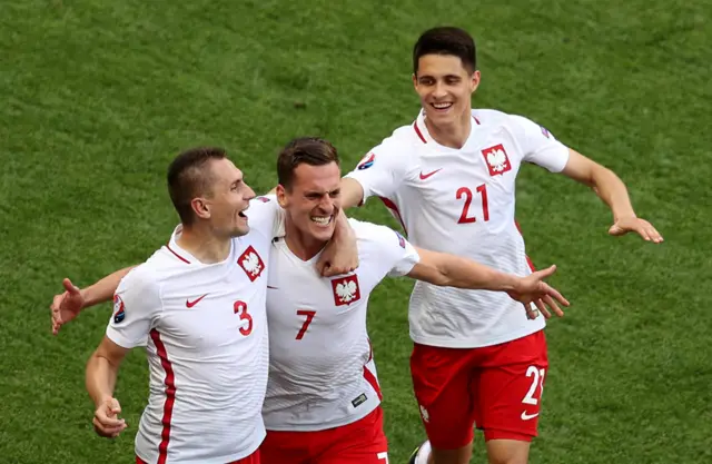 Poland celebrate their opening goal