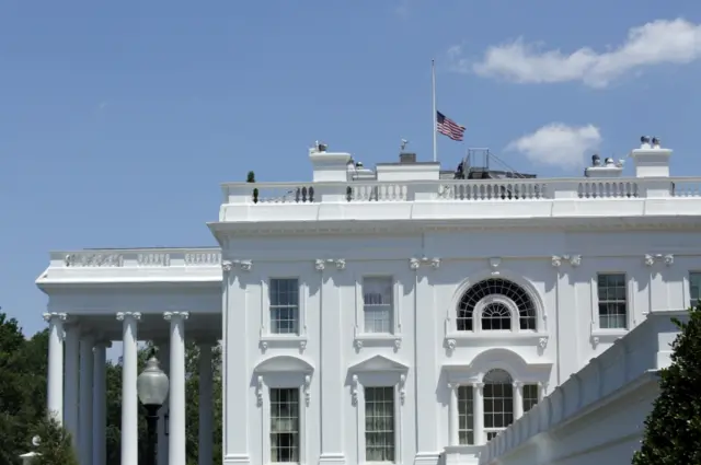 The US flag is seen at half-staff at the White House in Washington