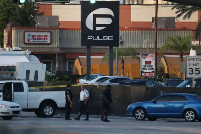 Law enforcement officials investigate near the Pulse Nightclub in Orlando on 13 June