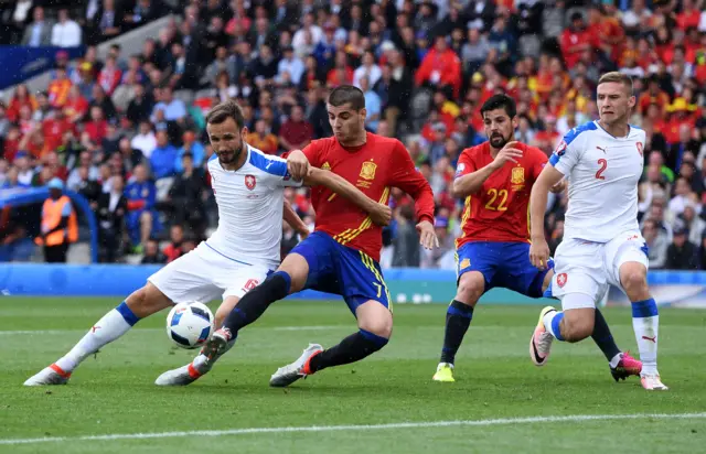 Alvaro Morata wrestles with his marker