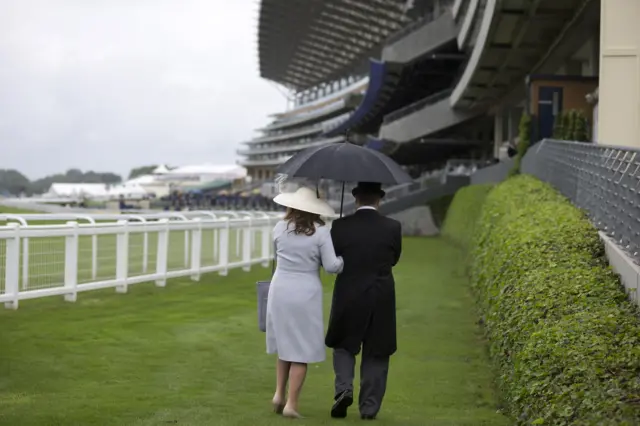 Racegoers in the rain