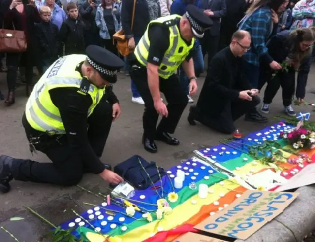 Two on-duty police officers were among those who lit candles for Orlando victims in George Square in Glasgow