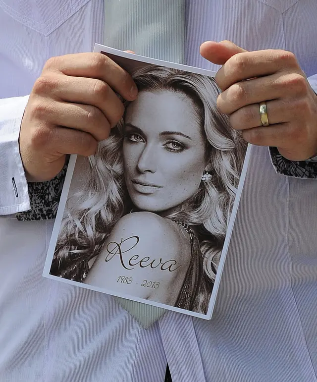 A relative of the late South African model Reeva Steenkamp holds the funeral ceremony program at the crematorium building in Port Elizabeth on February 19, 2013 after Steenkamp, 29, was shot four times in the early hours of February 14, 2013 by a 9mm pistol owned by South African sporting hero Oscar Pistorius