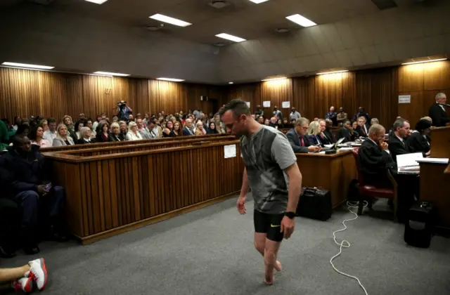 paralympic gold medalist Oscar Pistorius walks across the courtroom without his prosthetic legs during the third day of the resentencing hearing for the 2013 murder of his girlfriend Reeva Steenkamp, at Pretoria High Court, South Africa June 15, 2016.