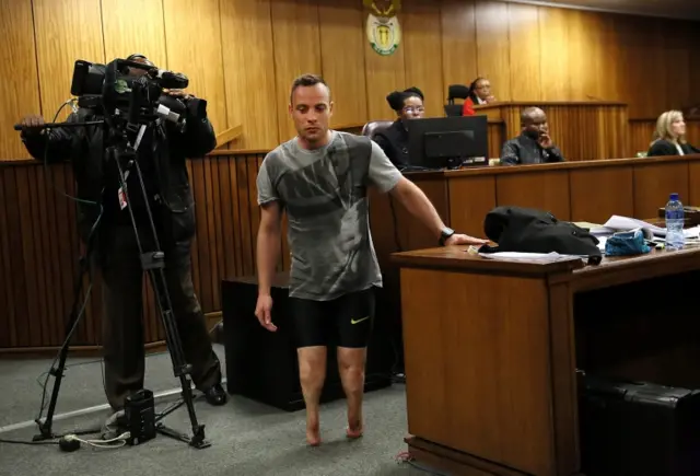 South African Paralympian Oscar Pistorius (C) walks without his prosthetic legs in the courtroom during proceedings on the third day of his sentencing hearing at the High Court in Pretoria, South Africa, 15 June 2016