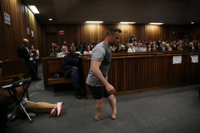 Paralympic gold medalist Oscar Pistorius walks across the courtroom without his prosthetic legs during the third day of the resentencing hearing for the 2013 murder of his girlfriend Reeva Steenkamp, at Pretoria High Court, South Africa, 15 June 2016