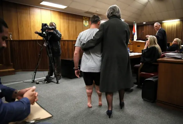 Oscar Pistorius (C) is aided as he tries to walk without his prosthetic legs in the courtroom during proceedings on the third day of his sentencing hearing at the High Court in Pretoria, South Africa, 15 June 2016