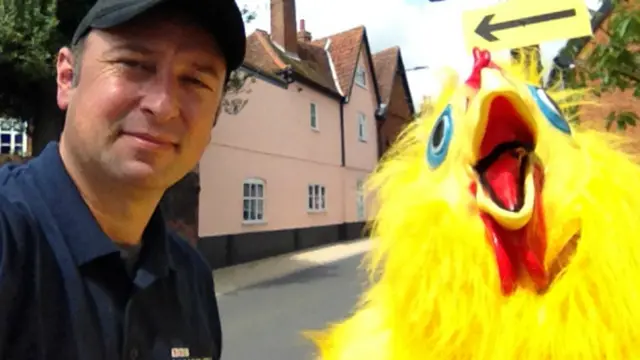 Guy and chicken mascot