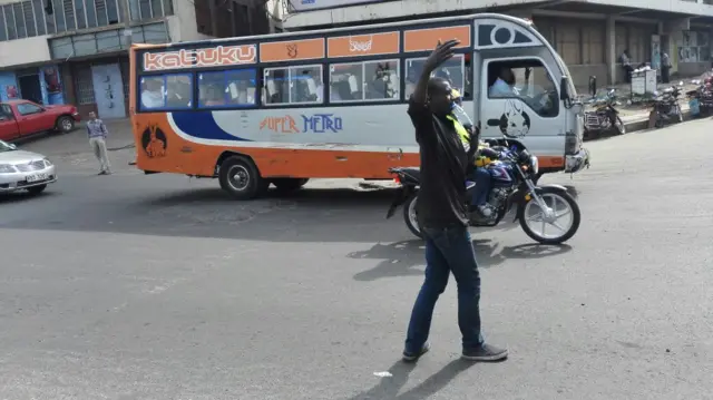 A boy directing traffic in Nairobi