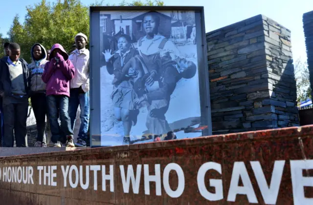 Children from Soweto stand at the Hector Pieterson Memorial in Soweto