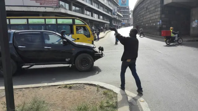 A boy in Kenya's capital, Nairobi, directing traffic