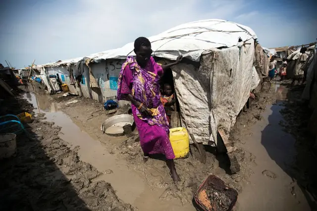 A woman walks outside her shelter in the Protection of Civilians (PoC) site in Malakal, on June 14, 2016.