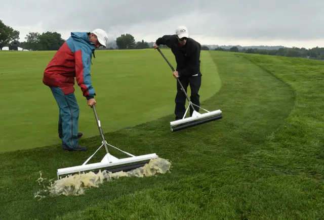 Ground staff roll the green