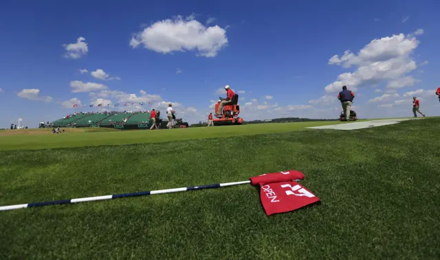 Groundsmen prepare the green ahead of the second round