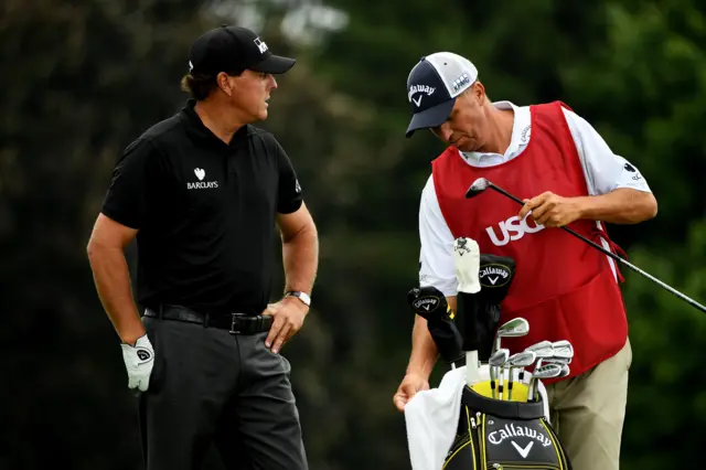 Phil Mickelson of the US talks with his caddy