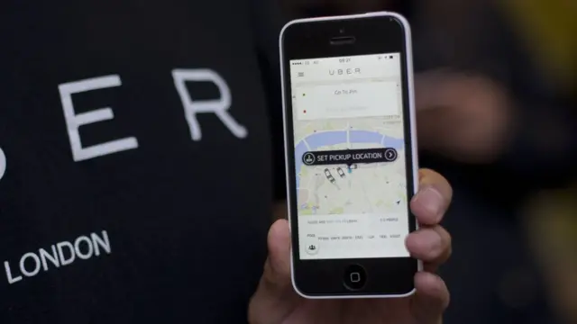 Man with Uber app open