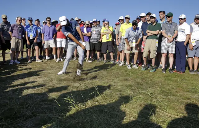 Jason Day hits a shot from the rough