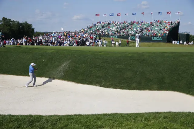 Dustin Johnson of the US hits from a bunker