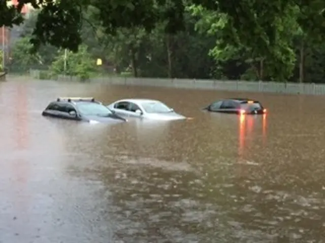 Cars in flooded car park at Cadbury's car park, Bournville