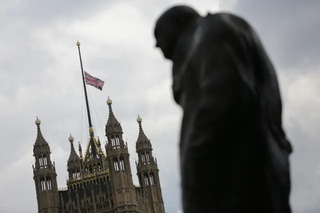 Flag at half mast over Parliament with Churchill statue