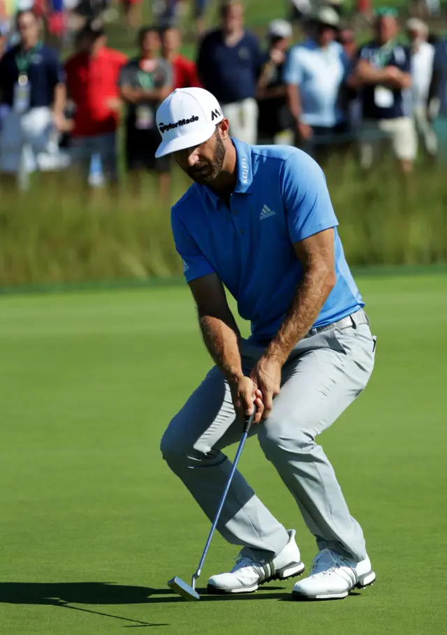 Dustin Johnson reacts to a putt