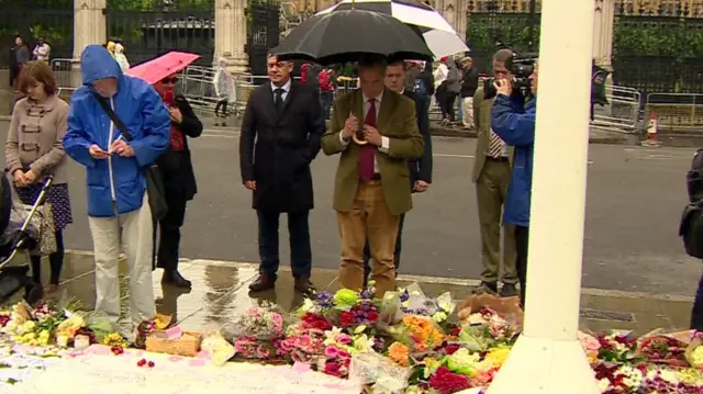 Nigel Farage lays flowers