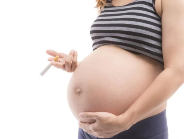 Pregnant woman holding cigarette