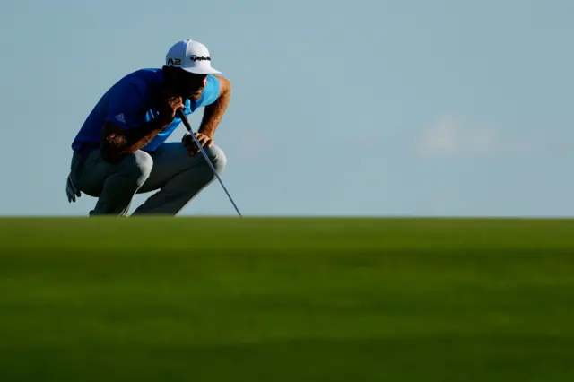 Dustin Johnson lines up a putt