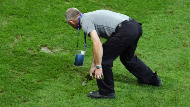 Ground staff trying to fix the pitch