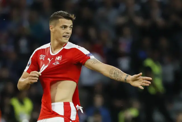 Granit Xhaka has his shirt ripped