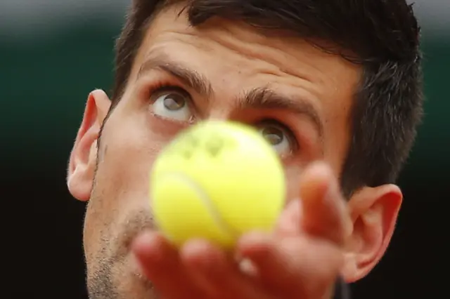 Novak Djokovic serves