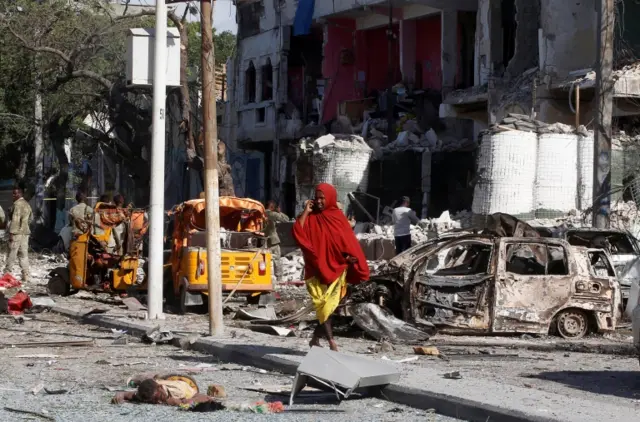 02/06/2016 Reuters A Somali woman walks in front of Hotel Ambassador on Maka Al Mukaram Road in Somalia"s capital Mogadishu, June 2, 2016.