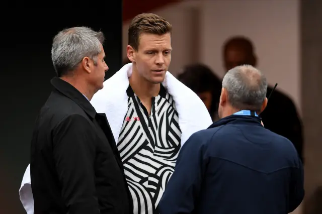 Tomas Berdych talks to the tournament officials