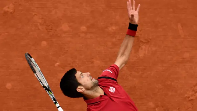 Novak Djokovic serves